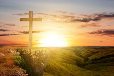 Christian Cross on the hill with sunset sky background