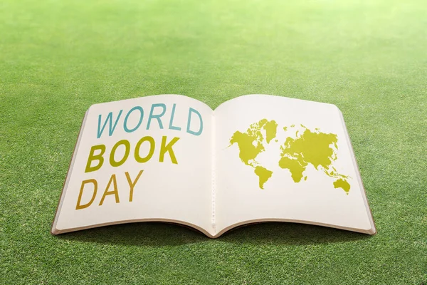 Opened book on the field. World Book Day Concept