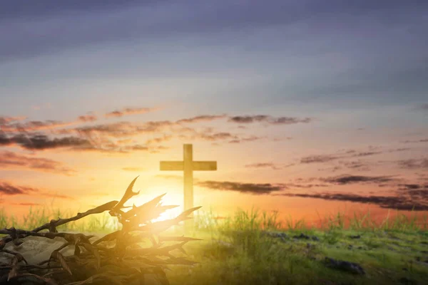 Christian Cross on the field with sunset sky background