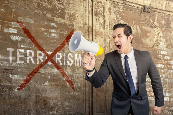 Бізнесмен Тримає Мегафон Знаком Припинення Тероризму Стіні — стокове фото