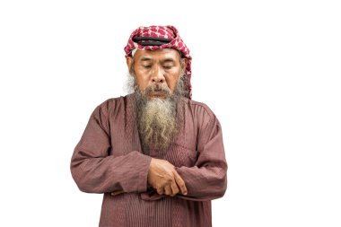 Sakallı ve sakallı Müslüman bir adam beyaz arka planda izole bir şekilde namaz kılıyor.