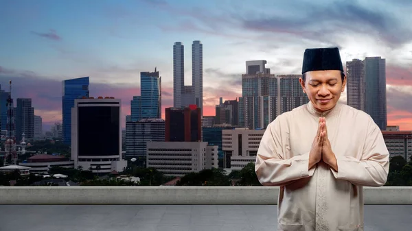 亚洲穆斯林男子 有城市背景的问候语 — 图库照片