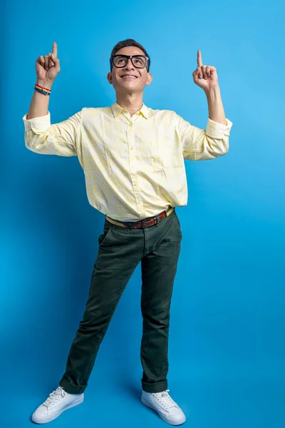 Muž Brýlemi Košilí Duhovém Náramku Ukazuje Něco Barevném Pozadí — Stock fotografie