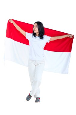 Indonesian women celebrate Indonesian independence day on 17 August by holding the Indonesian flag isolated over white background