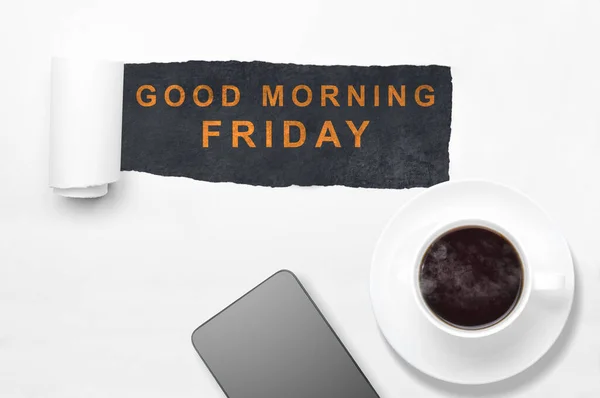 Mobile phone and coffee cup with a Good Morning Friday text. Happy Friday concept