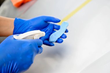 Man polishing car body in the garage
