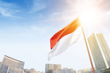 The red and white flag of Indonesian flag with blue sky background