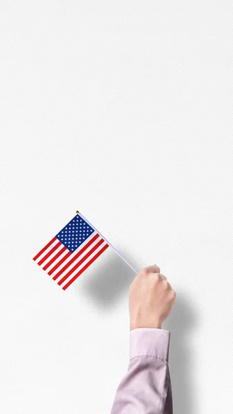 Human hand holding an American flag. Labor day concept