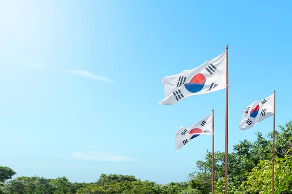 Korean flag waving in the sky. National Liberation Day of Korea concept