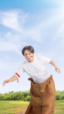 Indonesian men celebrate Indonesian independence day on 17 August with a sack race. Indonesian independence day