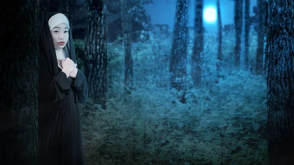 可怕的魔鬼修女晚上站在雾蒙蒙的森林里 万圣节可怕的女人 万圣节的概念 — 图库照片