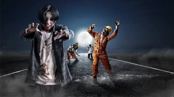 A group of scary zombies with blood and wounds on their bodies are walking on the asphalt road. Scary zombie. Halloween concept