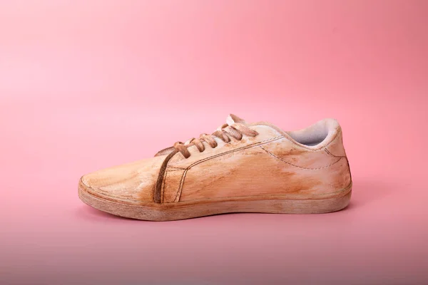 stock image Closeup view of dirty white sneakers on a colored background