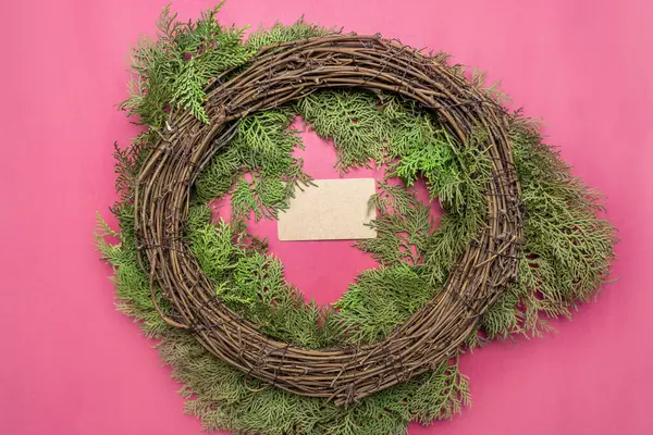 Making Christmas wreaths with empty business cards on a colored background. Christmas decoration concept. Empty business card for copy space