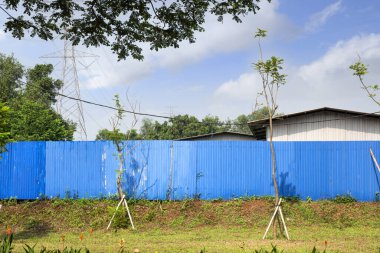 İnşaat alanındaki mavi gökyüzü arka planlı koruyucu çit.