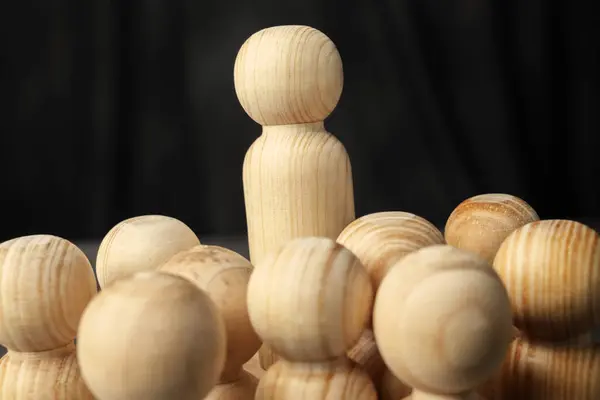 Stand out wooden figures from the crowd of wooden figures. Human resources management concept