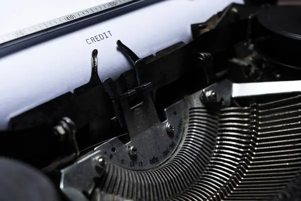 Text of CREDIT typed on a vintage typewriter. Financial concept