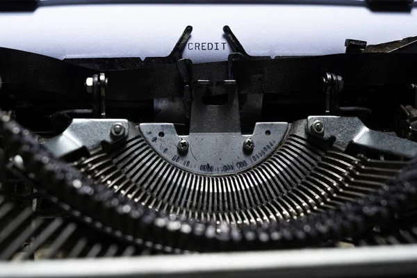 Text of CREDIT typed on a vintage typewriter. Financial concept