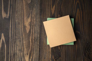 Closeup view of a stack of empty notepaper on a wooden background. Empty note paper for copy space