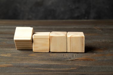 Closeup view row of wooden cubes on a wooden table