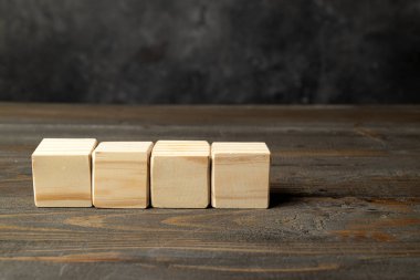 Closeup view row of wooden cubes on a wooden table