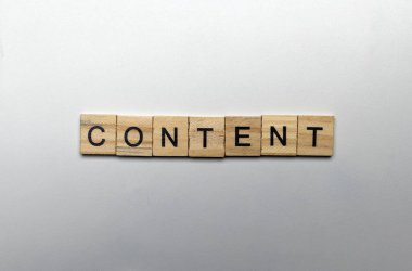 A row of wooden cubes with content letters on a white background. Content manager, strategy and creativity concept