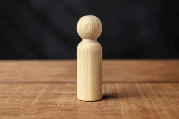 Closeup view of a wooden figure on a wooden table
