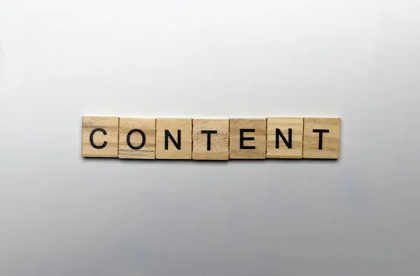 A row of wooden cubes with content letters on a white background. Content manager, strategy and creativity concept