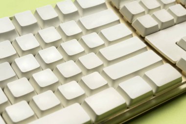 Closeup view of a computer keyboard on a colored background