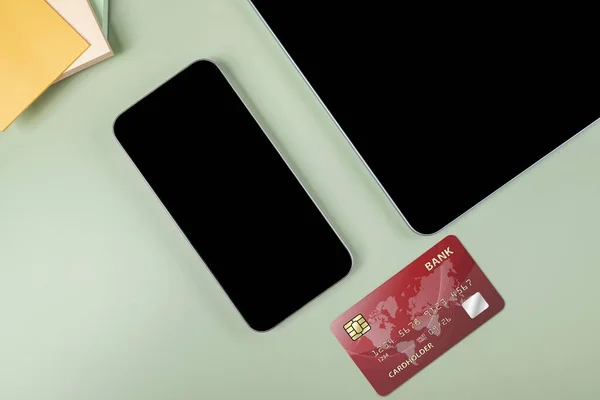 Credit cards and tablets with mobile phones with empty screens for mobile payment, banking, or online shopping. Empty tablet and mobile phone screen for copy space. Online payment concept