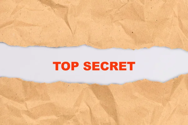 Ripped paper with text of top secret over a white background. Secret concept