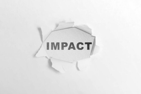 Ripped paper with impact text over a white background. Business impact concept