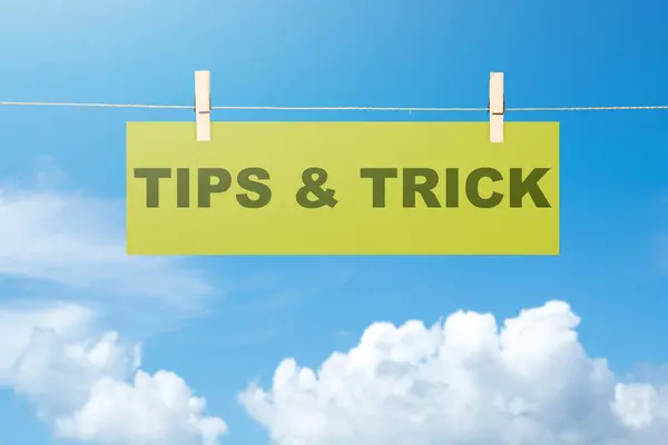 Paper hanging on the rope with 'Tips & Trick' text. Tips and advice concept