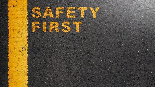 \'Safety first\' text on the asphalt road. Safety first concept