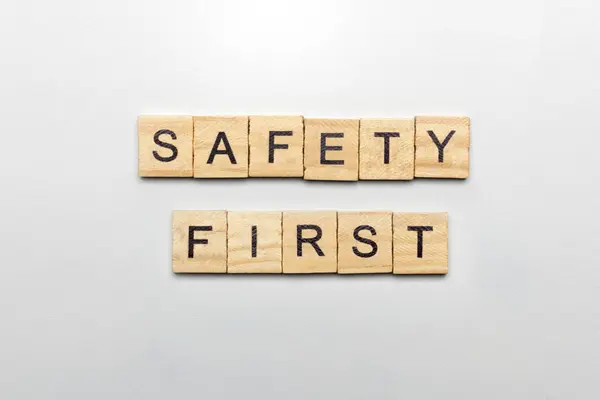 The row of wooden cubes with \'safety first\' text on a white background. Safety first concept