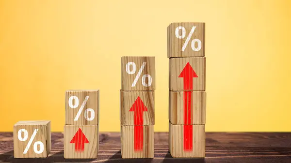 Stack of wooden cubes with the symbol of rising inflation rate graph arrow. Inflation concept