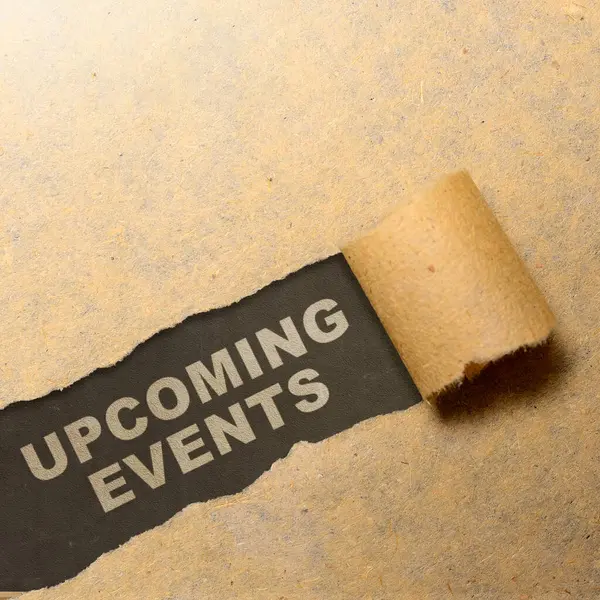 Ripped paper with \'upcoming events\' text with a black background. Event planning concept