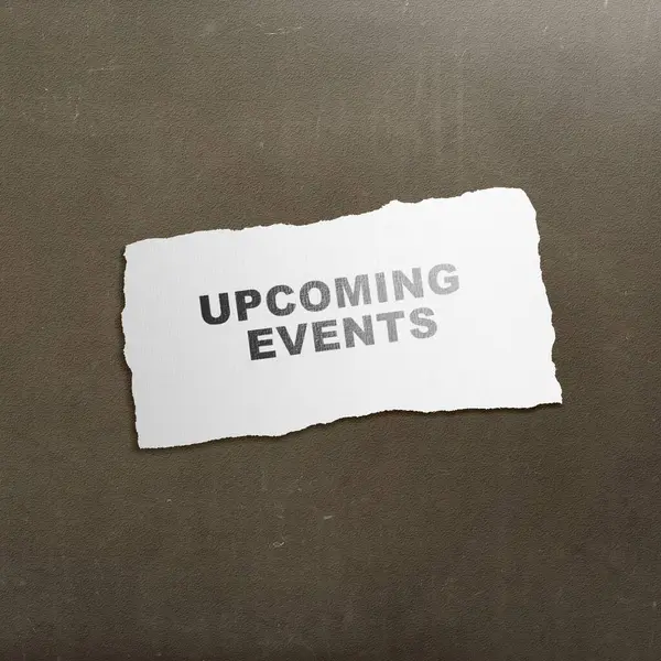 Ripped paper with \'upcoming events\' text with a black background. Event planning concept