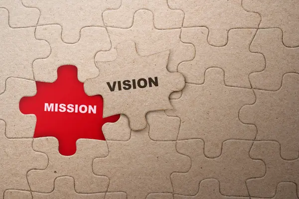 Piece of missing jigsaw puzzle with mission and vision text on a red background. Planning and target concept