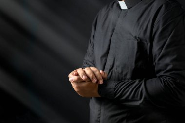 Siyah arka planda vaaz veren bir papazın portresi. Hıristiyan konsepti