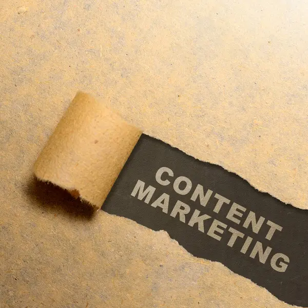 Ripped paper with content marketing text on a black background. Content manager, strategy and creativity concept