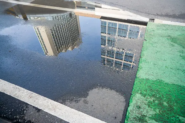 Closeup View Asphalt Road Puddle Reflection View Skyscrapers Jakarta Skyscrapers Royalty Free Stock Images