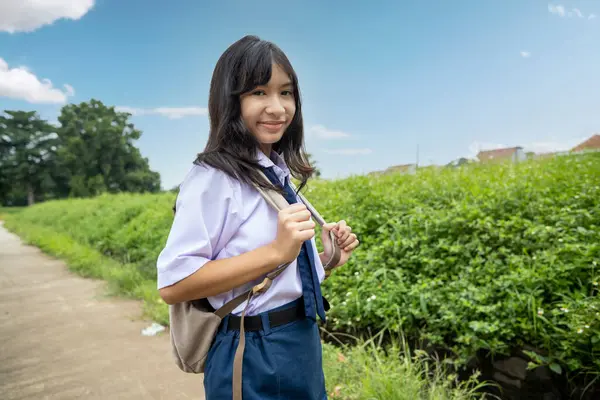 Young Female Indonesian Junior Hich School Uniform Wearing Backpack Going ஸ்டாக் புகைப்படம்