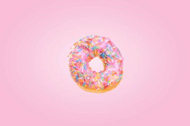 Renkli bir arka planda renkli bir süslemeyle nefis bir donut.