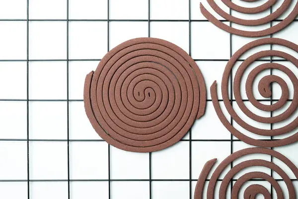 stock image A mosquito coils with a white background. The spiral is made of wood and has a brown color