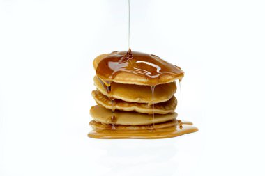 A stack of pancakes with syrup on top. The pancakes are stacked on top of each other and the syrup is dripping down the side. Concept of indulgence and comfort clipart