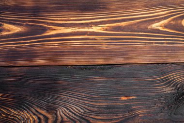 Tahta tahıl çok görünür ve ahşap yanmış. Yanmış odunun kırsal ve doğal bir havası var. Desenli arkaplan