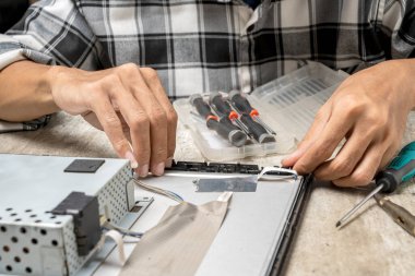 Erkek teknisyen televizyonu tamir ediyor. Hizmet, bakım veya onarım kavramı