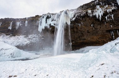 Seljalandsfoss şelalesinin İzlanda 'daki panoramik manzarası. Doğa, seyahat, kış arkaplanı veya duvar kağıdı