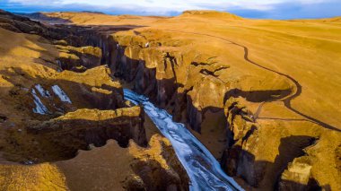 Aerial landscape view of Fjarrgljfur or Fjadrargljufur Canyon with Fjadrar river flow on Iceland. Taken by drone. Nature, travel, winter background, or wallpaper clipart